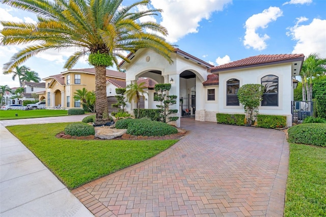 mediterranean / spanish-style house featuring a front yard