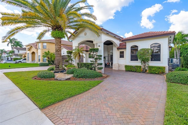 2294 SW 195th Ave, Miramar, FL 33029 - mediterranean / spanish-style home with stucco siding, a tiled roof, a front yard, decorative driveway, and cooling unit