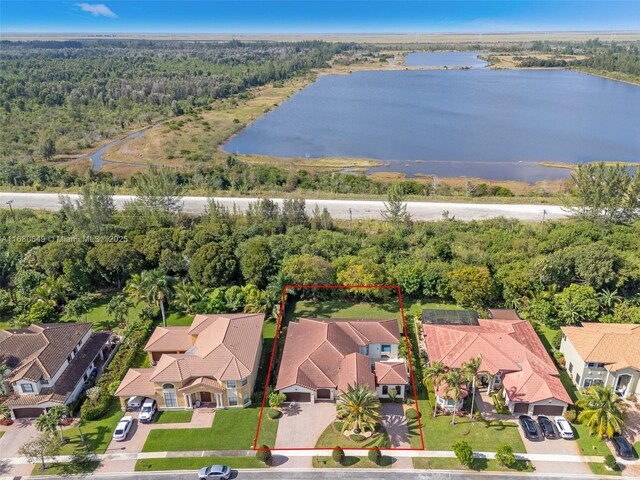2294 SW 195th Ave, Miramar, FL 33029 - aerial perspective of suburban area featuring property parcel outlined, a nearby body of water, and a forest