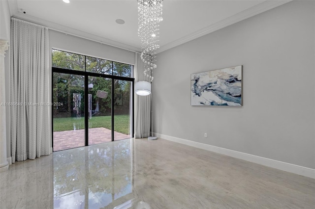 empty room featuring crown molding and an inviting chandelier