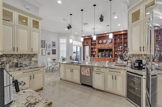 kitchen featuring pendant lighting, beverage cooler, and cream cabinetry