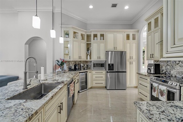 2294 SW 195th Ave, Miramar, FL 33029 - kitchen with appliances with stainless steel finishes, cream cabinetry, a sink, wine cooler, and recessed lighting