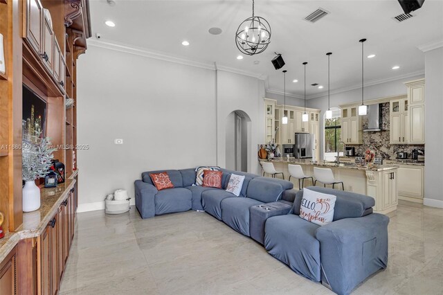 2294 SW 195th Ave, Miramar, FL 33029 - living room featuring ornamental molding, a chandelier, arched walkways, recessed lighting, and baseboards