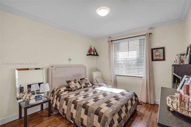 bedroom with dark hardwood / wood-style flooring and ornamental molding