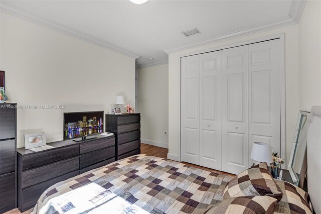 2294 SW 195th Ave, Miramar, FL 33029 - bedroom with crown molding, a closet, wood finished floors, and baseboards