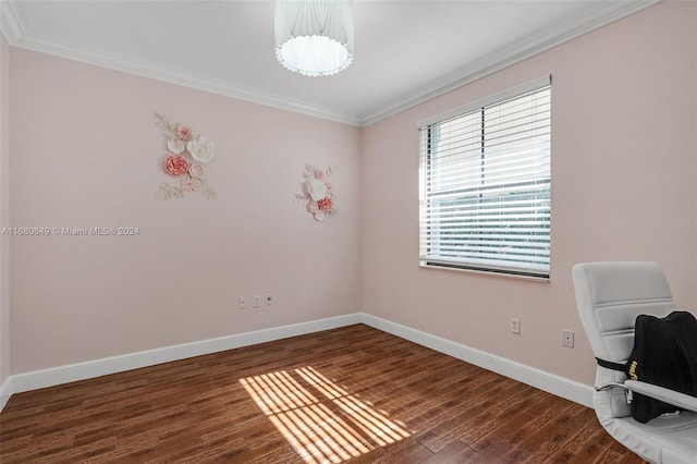 empty room featuring dark hardwood / wood-style flooring and crown molding