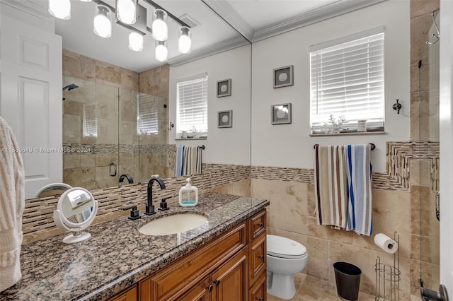 bathroom with a wealth of natural light, crown molding, vanity, and tile walls