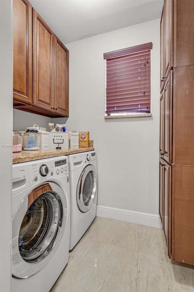 laundry room featuring cabinets and independent washer and dryer