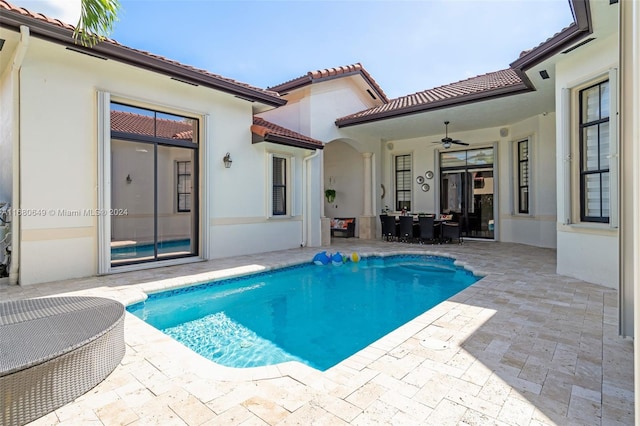 view of pool with ceiling fan and a patio