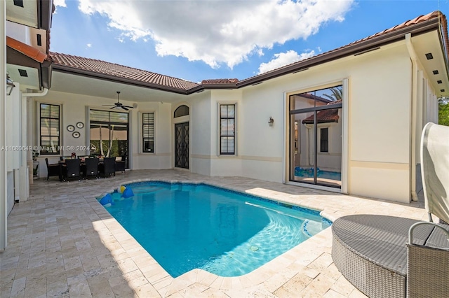 view of pool with ceiling fan and a patio area