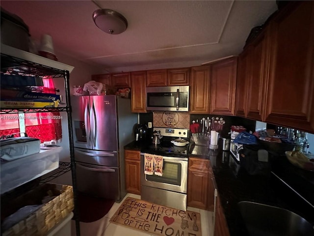 kitchen with stainless steel appliances and backsplash