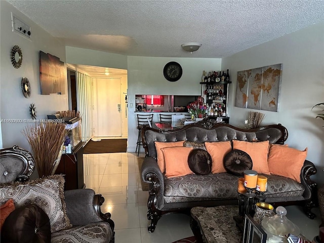 living room with a textured ceiling and tile patterned flooring