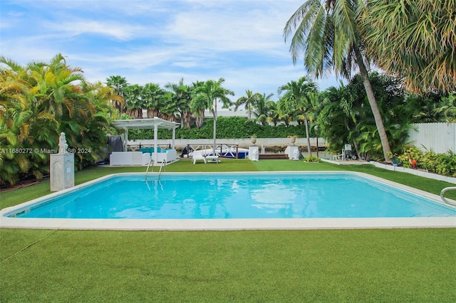 view of pool featuring a lawn and a pergola