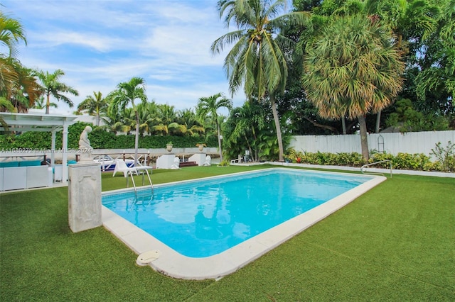 view of swimming pool featuring a yard and a pergola