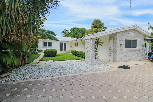 rear view of house featuring a lawn