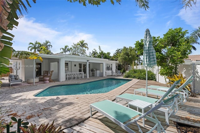 view of swimming pool with a patio and a wooden deck