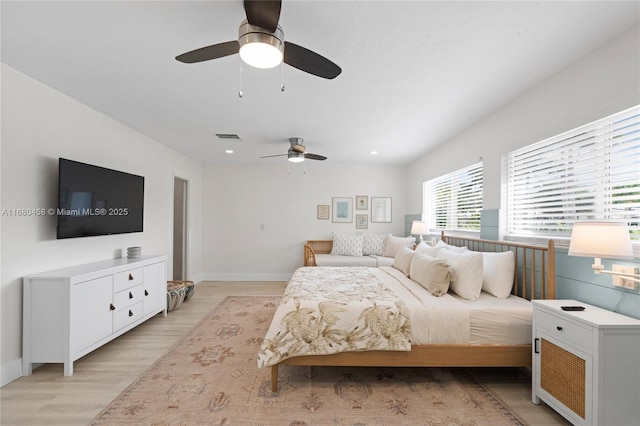 bedroom with ceiling fan and light hardwood / wood-style flooring