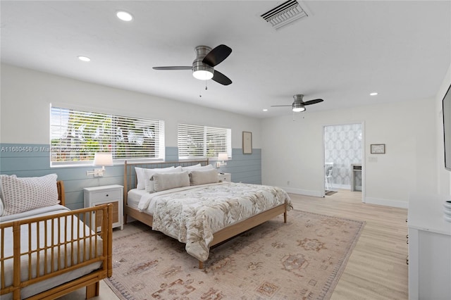 bedroom with ceiling fan and light hardwood / wood-style floors