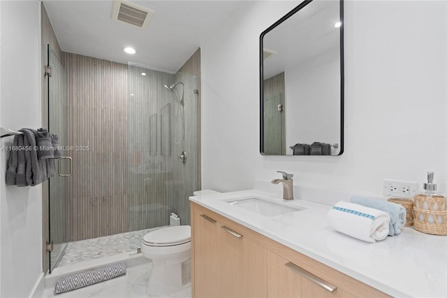 bathroom with vanity, an enclosed shower, and toilet