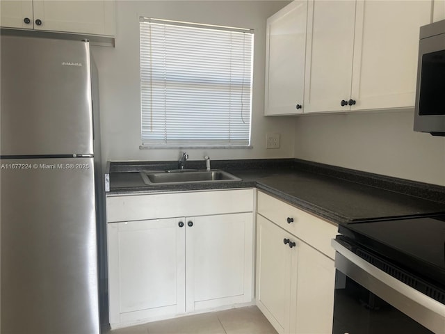 kitchen featuring white cabinetry, appliances with stainless steel finishes, and sink