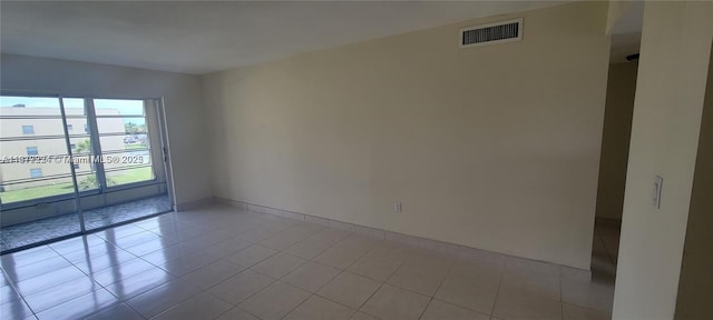 unfurnished room featuring light tile patterned floors