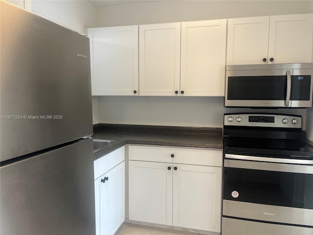 kitchen with appliances with stainless steel finishes and white cabinets