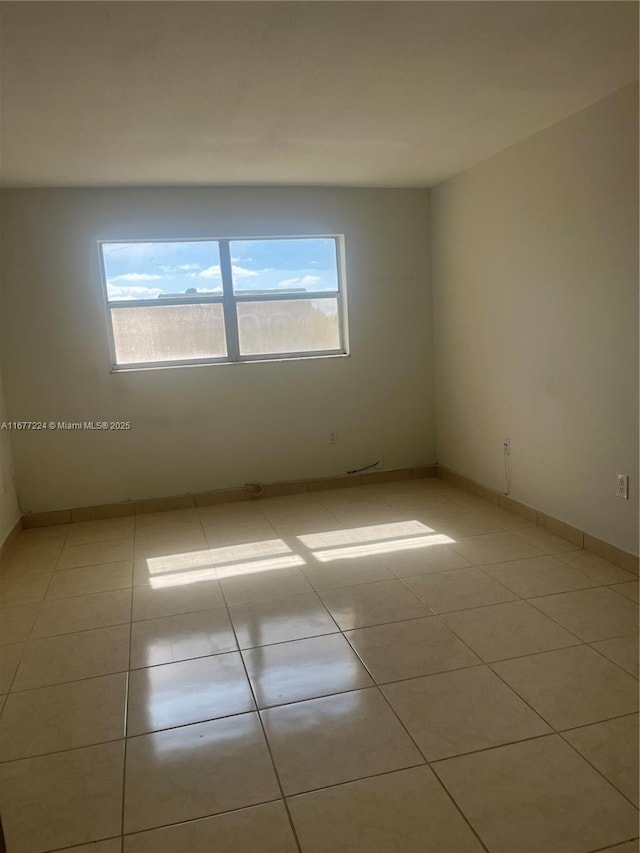 spare room with light tile patterned floors