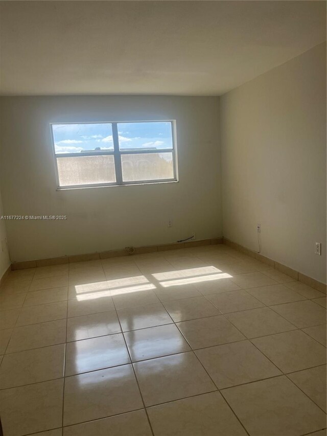 unfurnished room featuring light tile patterned floors