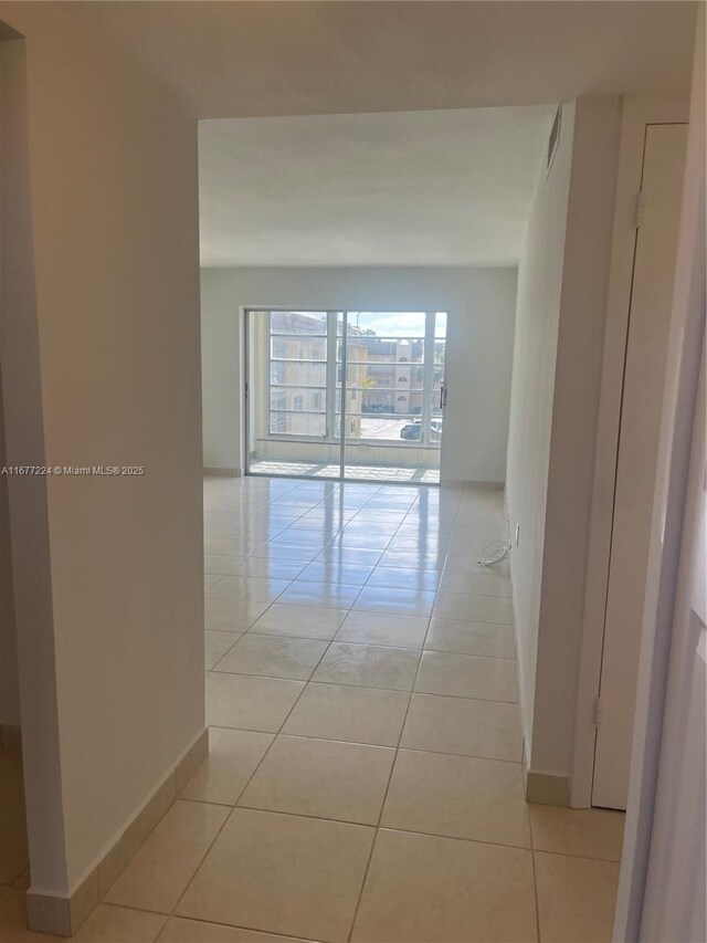 8285 Sunrise Lakes Blvd Unit 308, Sunrise, FL 33322 - spare room with healthy amount of natural light, light tile patterned floors, and baseboards