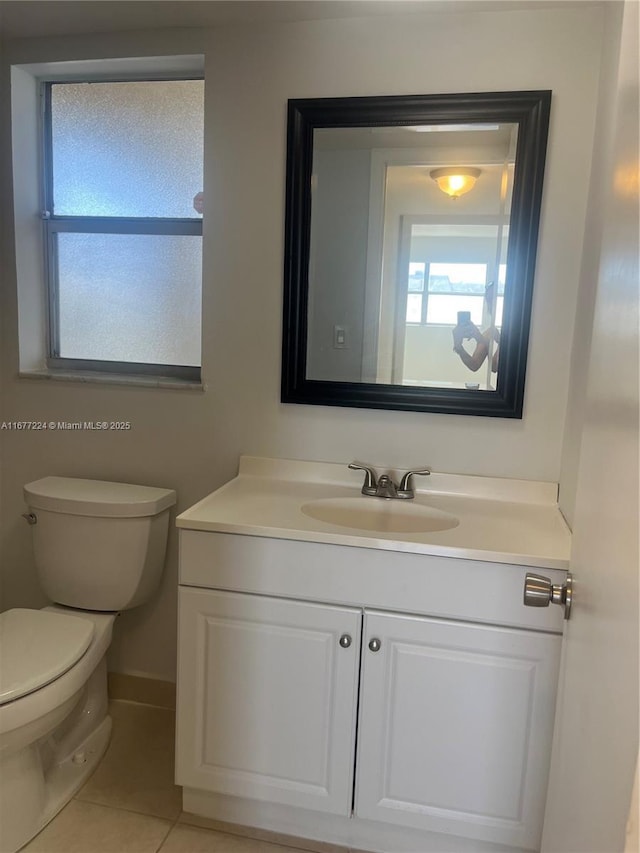 bathroom featuring vanity, tile patterned floors, and toilet