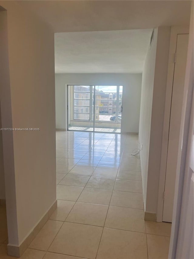 hall featuring light tile patterned flooring