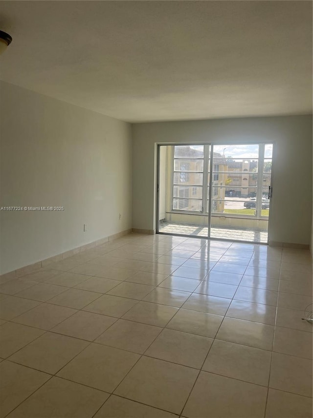 spare room with light tile patterned floors