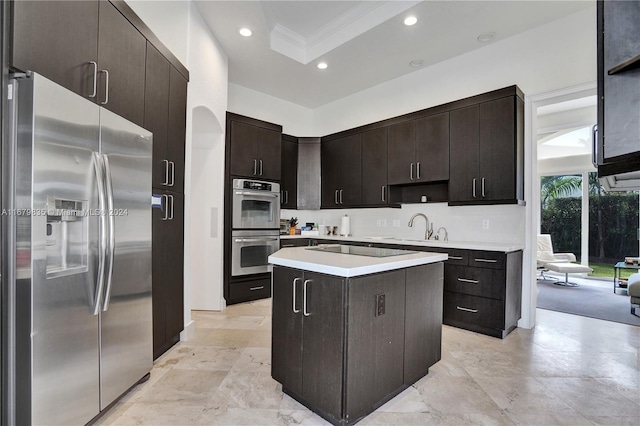 kitchen with a center island, sink, crown molding, dark brown cabinetry, and stainless steel appliances