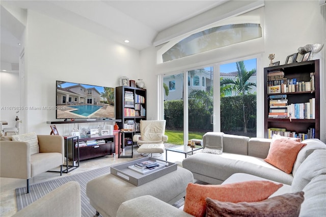 living room featuring a towering ceiling and light tile patterned flooring