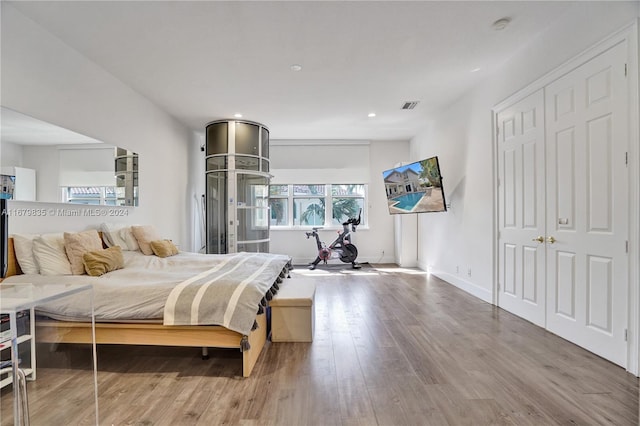 bedroom with hardwood / wood-style flooring and a closet