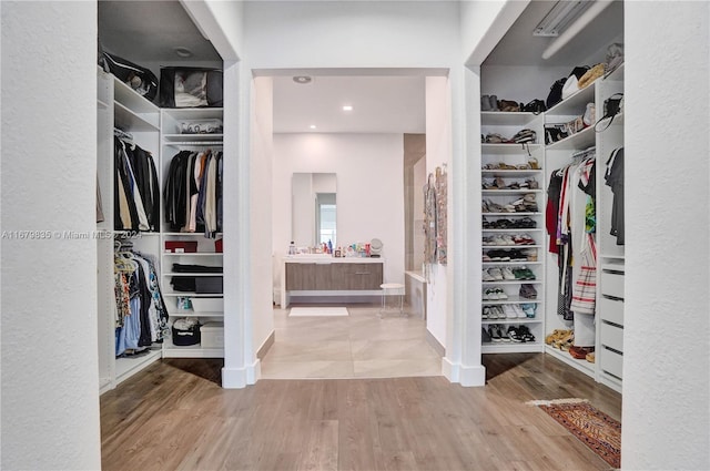 walk in closet with wood-type flooring