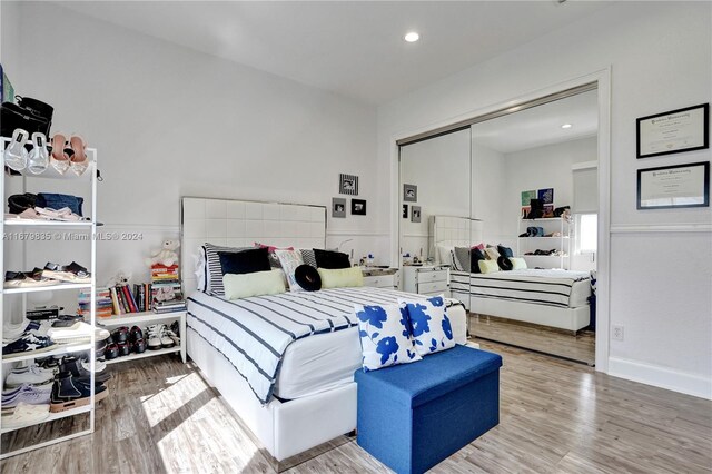 bedroom with hardwood / wood-style flooring and a closet