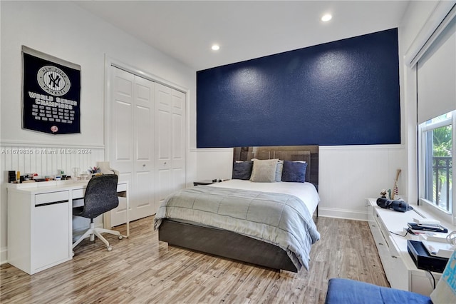 bedroom featuring a closet and light wood-type flooring