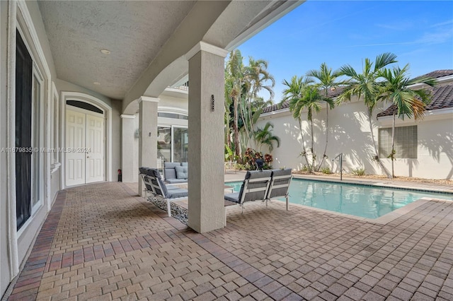 view of swimming pool with a patio and an outdoor hangout area