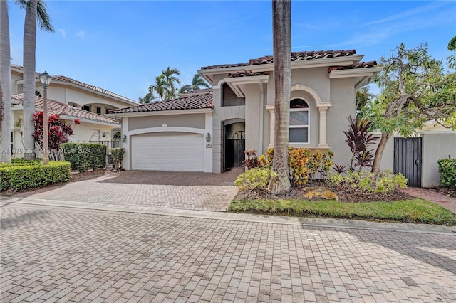 mediterranean / spanish home featuring a garage