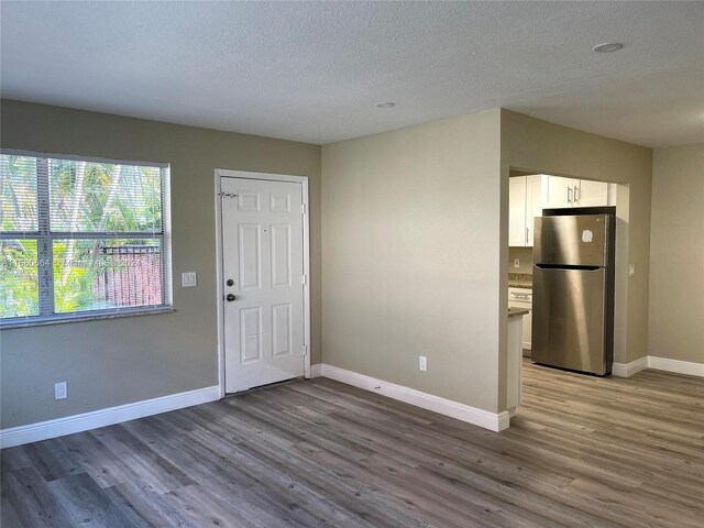 400 NW 65th Ave Unit 120, Margate, FL 33063 - foyer entrance featuring wood finished floors and a textured ceiling