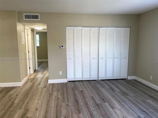 400 NW 65th Ave Unit 120, Margate, FL 33063 - unfurnished bedroom with wood finished floors and a closet
