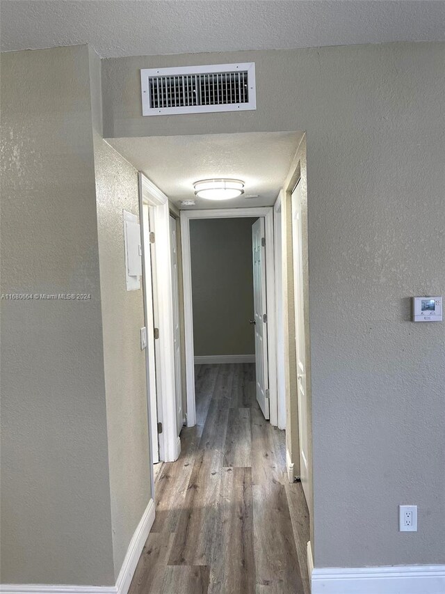 400 NW 65th Ave Unit 120, Margate, FL 33063 - corridor with wood finished floors and a textured wall