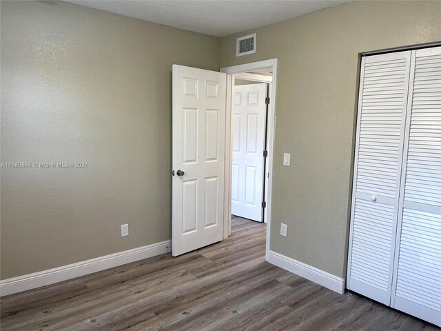 400 NW 65th Ave Unit 120, Margate, FL 33063 - unfurnished bedroom featuring wood finished floors and a closet