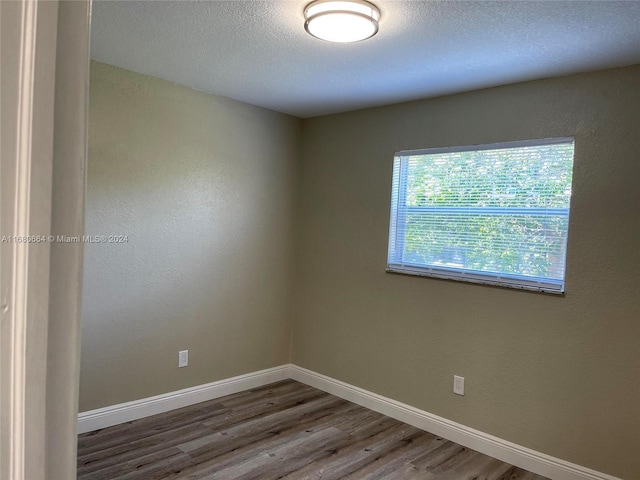 400 NW 65th Ave Unit 120, Margate, FL 33063 - unfurnished room with wood finished floors and a textured ceiling