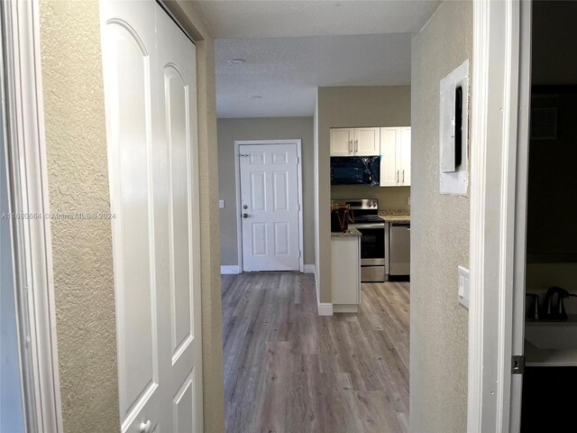 400 NW 65th Ave Unit 120, Margate, FL 33063 - corridor featuring light wood-type flooring and a textured wall
