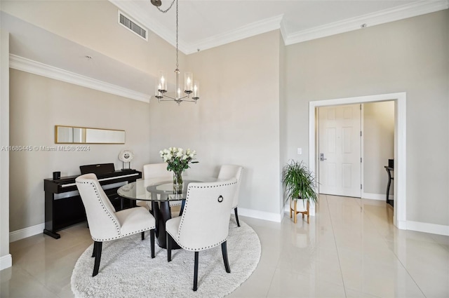 dining area with a high ceiling, ornamental molding, light tile patterned floors, and an inviting chandelier