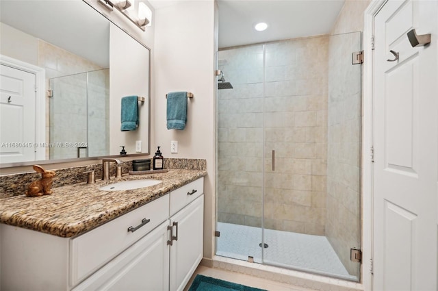 bathroom featuring vanity and an enclosed shower