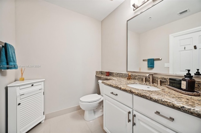 bathroom featuring toilet, vanity, and tile patterned floors