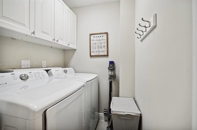 washroom with washer and clothes dryer and cabinets